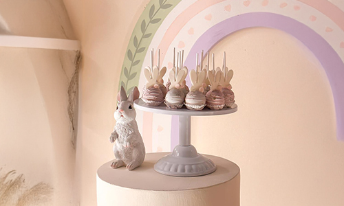 Elegant children’s dessert display with bunny cake pops in soft pastel tones