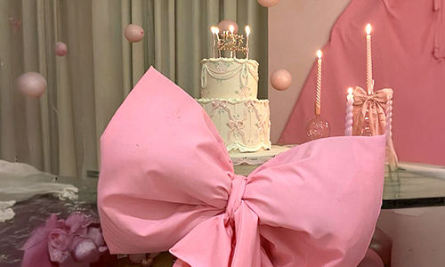 Coquette pink bow custom cake for women featuring an oversized fondant bow, soft pastel pink cake design, and elegant celebration styling for birthdays and special events.